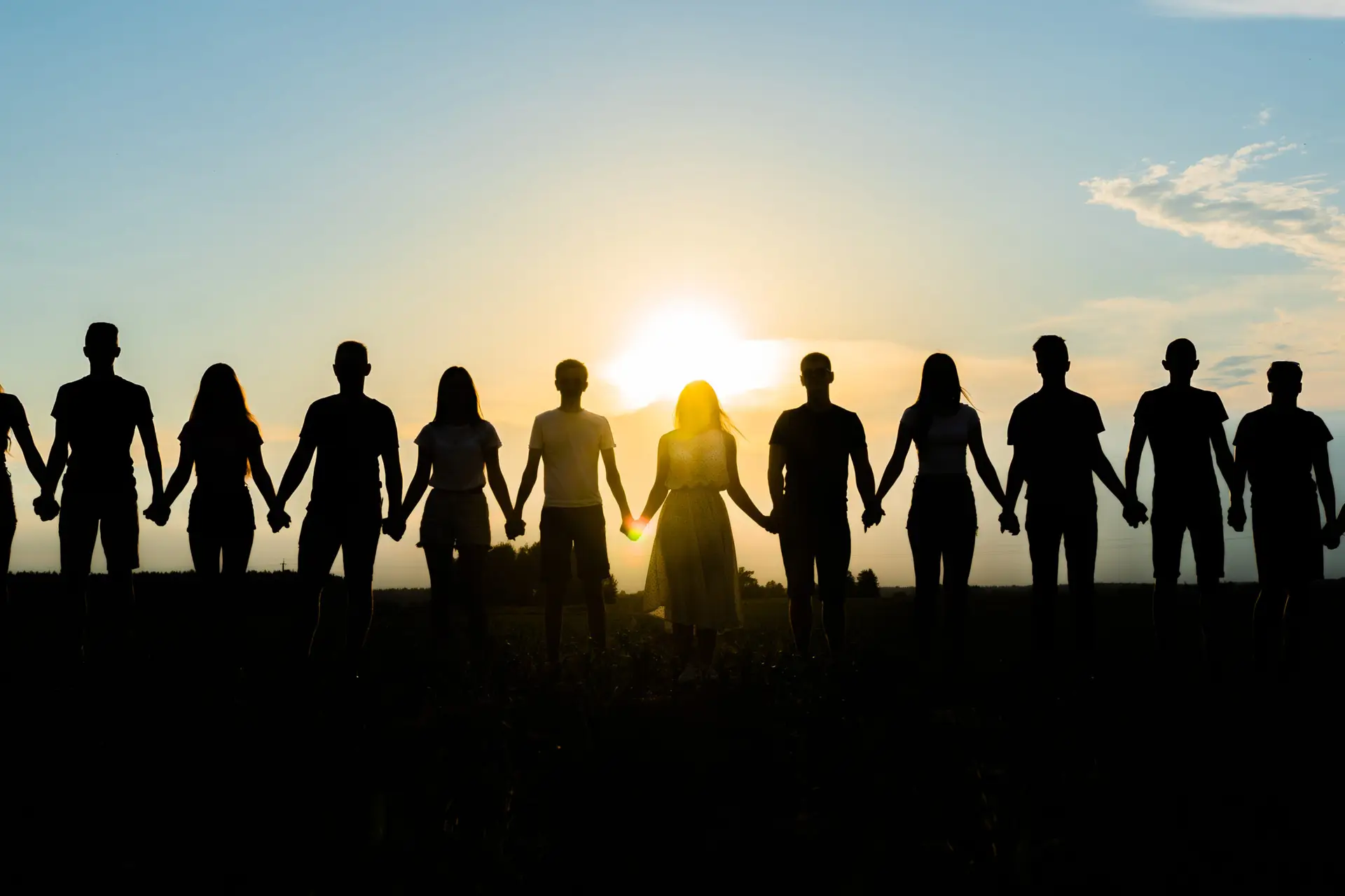 Silhouetted, Diverse Group Holding Hands At Sunset—Symbolizing The Maxim Clinic’s Inclusive, Patient-First Wellness Promise In Marietta &Amp; Norcross, Georgia