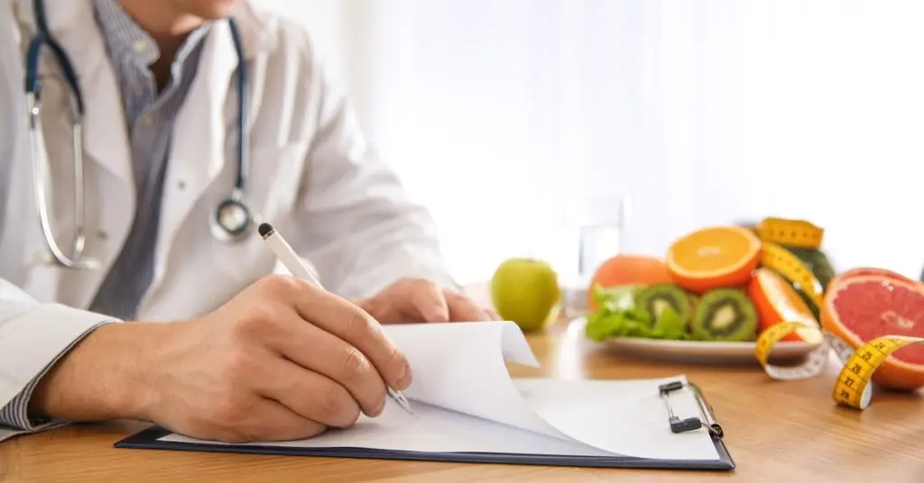 Physician preparing notes with fruit and tape measure in background, representing Semaglutide weight loss treatment and FDA approval insights.