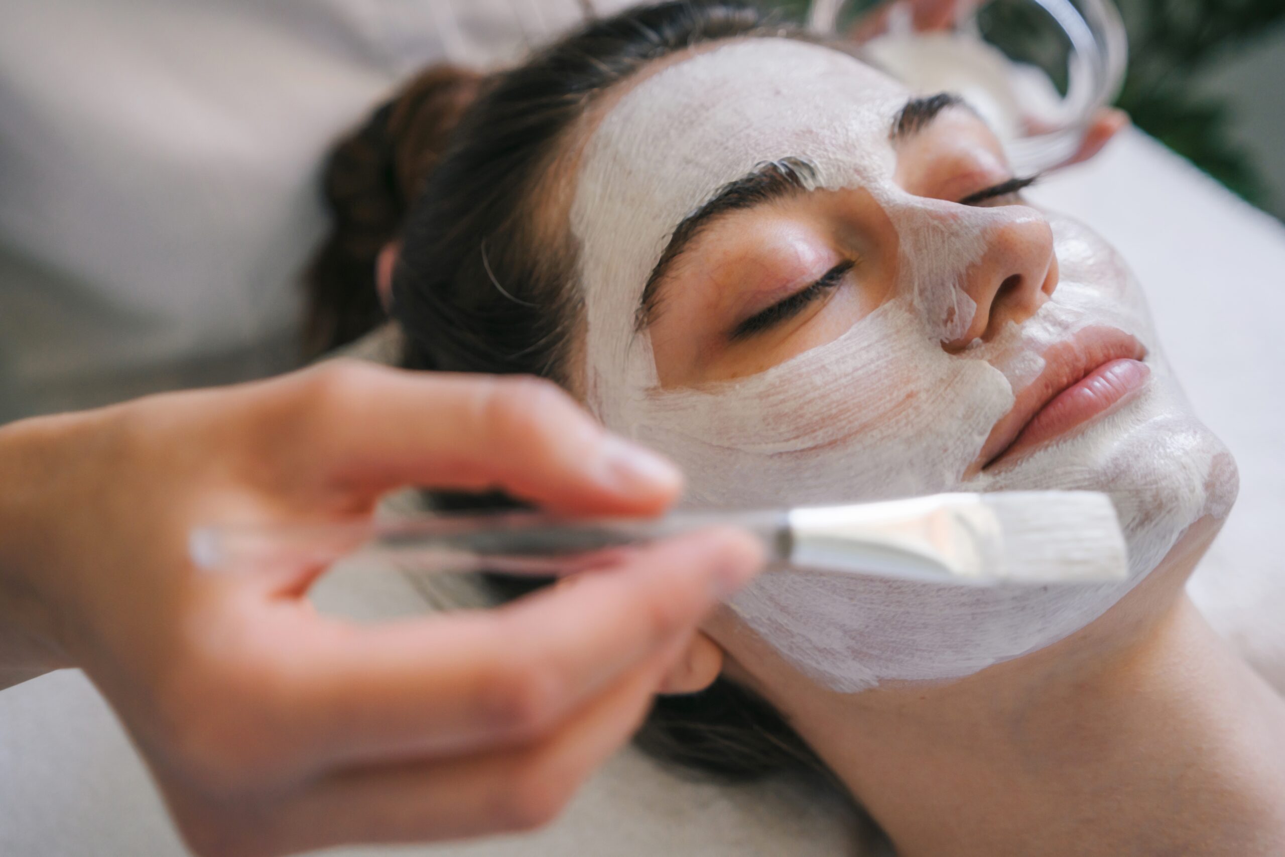 Client relaxing while receiving a signature facial at The Maxim Clinic