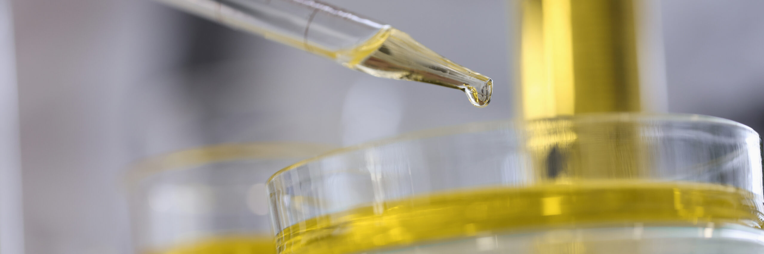 A clean, scientific image of a chemical peel solution in a dropper