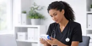 Physician in black scrubs reviewing tirzepatide medication to verify safety and authenticity